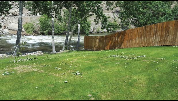Courtesy of Stillwater County DES Coordinator Carol Arkell Rocks from the river can be seen on this lawn, located in Midnight Canyon, directly across from the slide. The homeowner was evacuated.