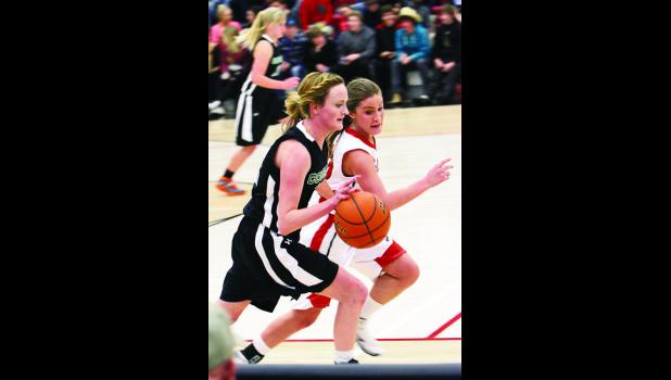 Ardona Robbins Hailey Campbell barrels down the court under heavy defense from Huntley Project Red Devils.