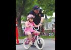 Columbus Police Officer Jacob Ward helps Brea Sandoval navigate the Bike Rodeo course last Thursday.
