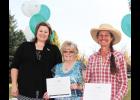 From the left: Columbus Community Foundation board member Marissa Hauge presents annual grants to Joyce Terrel, of the Compassionate Friends of Stillwater Valley, and Cindy Green, chairman of the Stillwater Valley Watershed Council, at Heritage Park in Columbus on Oct. 12.