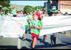 Landan DeBruycker leads a field of more than 100 runners and walkers through the start line at last Saturday’s Living the Dream Fun Run in Columbus. Robin DeBruycker is seen in the background with both hands over her head, signaling the start of the event.
