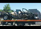 The remnants of the pickup truck on a flatbed trailer following the crash.