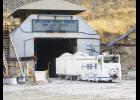 A muck truck brings material out of the east portal of the Nye mine site.