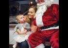 A little girl keeps a close eye on Santa during a photo session last Friday night at Beartooth Ford, courtesy of First Interstate Bank as part of the Columbus Parade of Lights celebration.