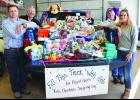  Beartooth Ford workers Randy House and Mike Pulse flank a truck full of goodies with owners Wes and Tonya House. The goodies are all donated items by community members and businesses that will be used in the Project Hope Kids Shopping Day this Sunday at the fairgrounds. Beartooth Ford will also be the site of the chili feed and Santa visit this Friday for the Columbus Parade of Lights.